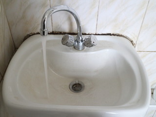 white sink with a tap for water