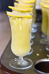 Apple sorbet in a tall glass with a piece of quince