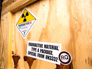 Radiation label beside the transport wooden box Type A package