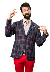 Well dressed man making tiny sign on white background