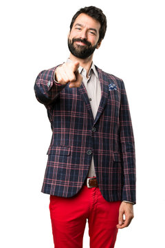 Well dressed man pointing to the front on white background