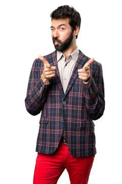 Well dressed man pointing to the front on white background