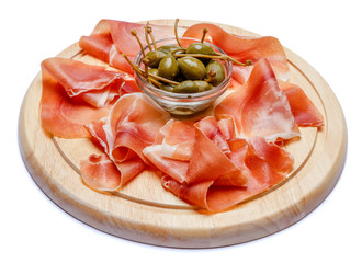 Meat plate of Italian prosciutto crudo or spanish jamon on wooden cutting board