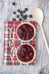 Two fruit tarts with blueberries on a wooden background 