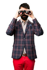 Well dressed man with binoculars on white background