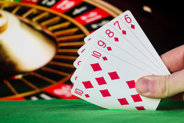 Straight flush poker cards combination on blurred background casino luck fortune card game