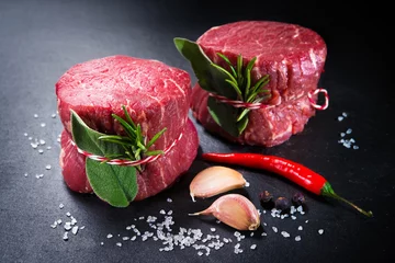 Gordijnen Raw beef fillet steaks mignon on dark background © Alexander Raths