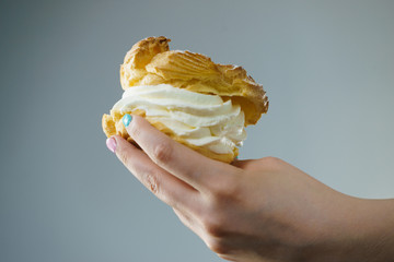 Woman holding sweet delicious cream cupcake