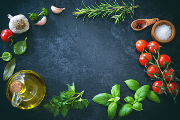 Olive oil, tomatoes, garlic, parsley, basil, spices on dark background with water drops