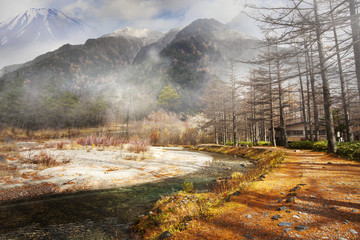  image of evening mountains and high trees with snow and river