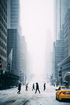 People walking on city street in winter