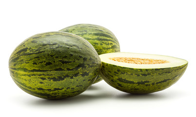 Two melons Piel de Sapo with one section half (Santa Claus Christmas variety) isolated on white background green striped outer rind.