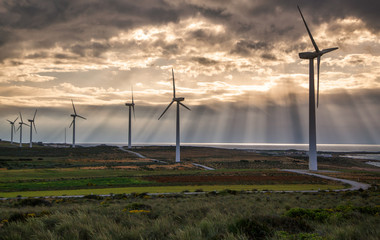 The Wind turbine stand with amazing nature of the sun ray and cloudy. In Tunisia has nature energy and there is the one of landmark in Tunisia,  Alternative and clean energy concept.