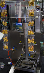 Cookie snack vertical filling and sealing machine. Food pouch packaging.