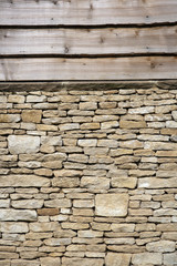 Feather edge timber cladding above a drystone wall