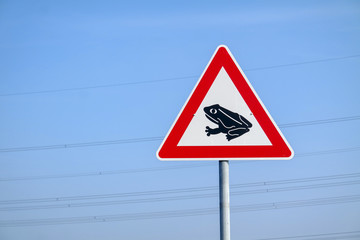 Frogs crossing the road warning sign