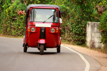red autorickshaw on the road