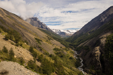 Landscape in Torres del Paine. Valley in the Torres del Paine National Park in Chile. Patagonia. The river and the path climbing to the Torres del Paine area at the back in the left