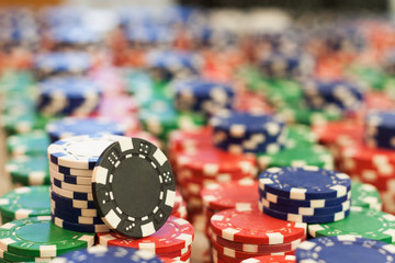 Multicolored poker chips exhibited by a pile