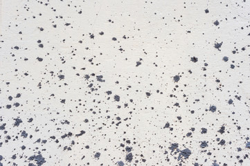 Texture A white slightly cracked wall is carelessly stained with a spray of blue-gray cement...