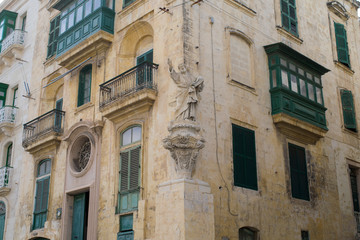 Fototapeta na wymiar Statue on the corner of streets in the city of Senglea, Three Cities, Malta