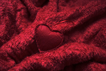 red heart on fluffy red blanket