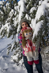 A frozen girl in a forest with a doll about ate.