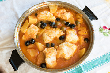 Salted cod stewed with olives