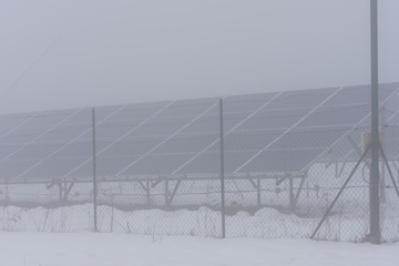 winter time and solar collectors in fog