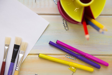 Stationery on colored wooden background