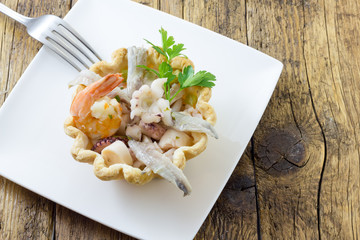 Seafood appetizer in puff pastry basket