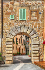 old gate and the street in medieval tuff city of Sorano, Tuscany, Italy