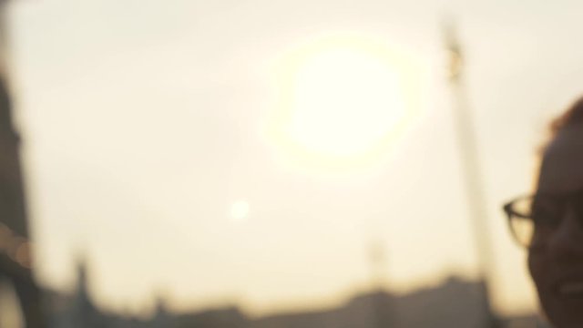 Happy woman and man giving five on sunny evening background close up