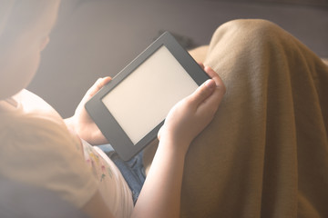 Girl is reading ebook on digital tablet device
