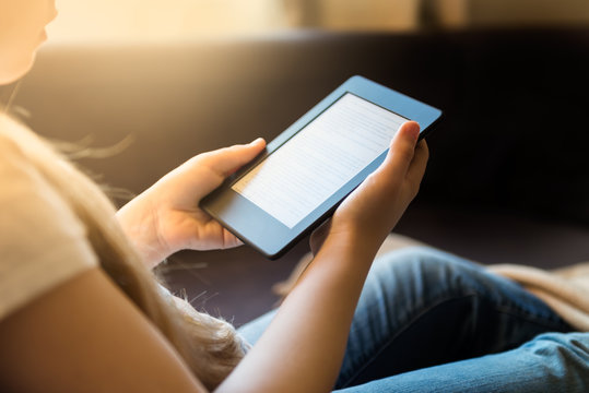 Girl is reading ebook on digital tablet device