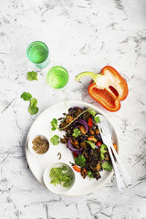 Wild rice baked vegetables vegetarian bowl. Sweet potatoes, red onions, peppers. On a light background. Food concept.