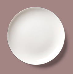 Single plate isolated on a colorful background viewed directly above. Top view