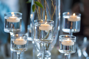 floating votive candles in stemware for reception