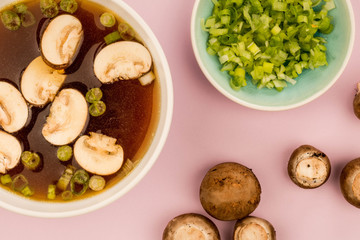Bowl Of Japanese Style Clear Onion Soup With Mushrooms and Spring Onions