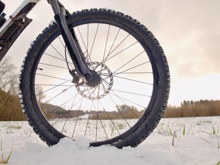 Front wheel of mountain bike while snow riding.