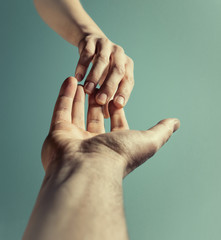 Emotional photo of two hands at the moment of farewell. The concept of breaking relations.