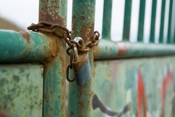 Padlock on the gate in the meadow fence. Slovakia