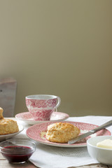 Homemade bread scones with hot tea, traditional British pastries.