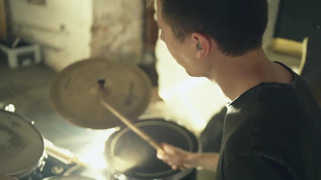 Man playing drums during rehearsal in studio