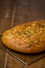 freshly baked italian focaccia bread on rustic wooden table
