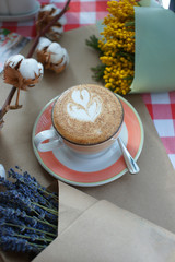 Cappuccino and dried flowers on a table