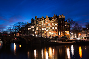 Fototapeta na wymiar Amsterdam canal houses illuminated at dusk