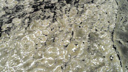 Ice comes to the river bank.