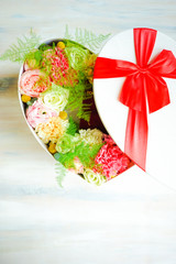 Heart shaped box  with roses and anemone flowers
