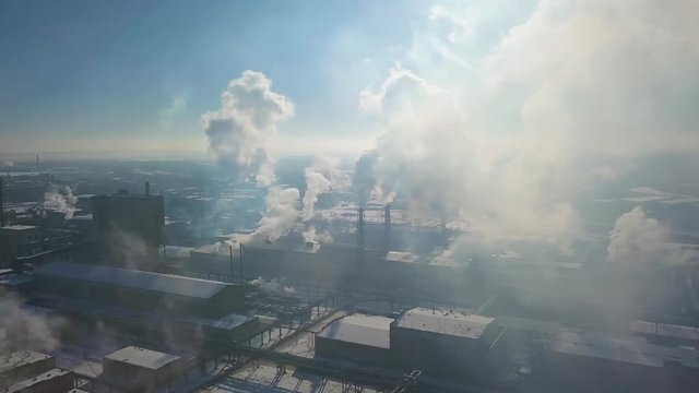 Aerial view of factory smoke stack - Oil refinery, petrochemical or chemical plant in winter